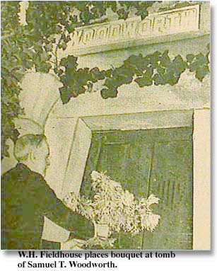 W. H. Fieldhouse places bouquet of flowers at tomb of Samuel T. Woodworth
