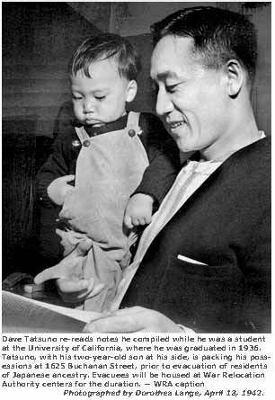 Dave Tatsuno re-reads notes he compiled while he was a student at the University of California, where he was graduated in 1936. Tatsuno, with his two-year-old son at his side, is packing his possessions at 1625 Buchanan Street, prior to evacuation of residents of Japanese ancestry. Evacuees will be housed at War Relocation Authority centers for duration. 
-- WRA caption. Photographed by Dorothea Lange,  San Francisco, April 13, 1942.